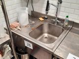 a kitchen with a stainless steel sink and a stainless steel counter