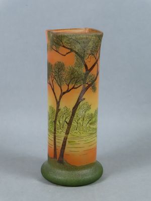 a vase with a painting on it sitting on a table