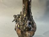 un vase en argent posé sur une table