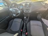 the interior of a small car with a steering wheel and dashboard