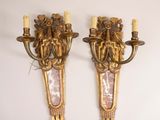 pair of antique wall sconces with gilded glass panels and candles