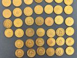 a bunch of gold coins sitting on top of a table