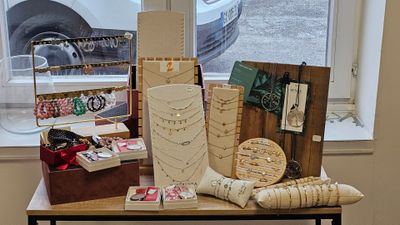a table with various items on it in front of a window