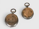 pair of antique pocket watches with engraved dials on each side