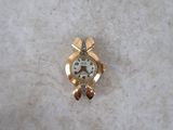 a small gold watch on a white surface