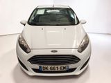 the front of a white ford fiesta parked in a white room