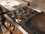 a stove top with a pan on it in a kitchen