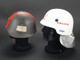 pair of white hard hats and a white hard hat on a stand