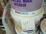 several buckets of paint are stacked on top of each other