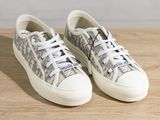 the sneakers are on a wooden surface with white laces