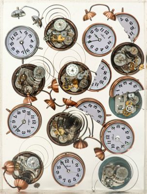 a picture of a display of different clocks on a wall