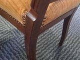 a wooden chair with a yellow upholstered seat