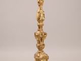 an image of a gold candle holder sitting on top of a table