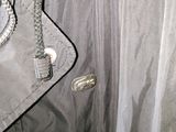 an image of a coat hanging on a hanger in a room