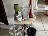 a table with cups and vases on it in a room