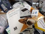 a dog sitting on top of a pile of electronics