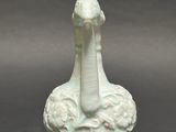 a white vase with a bird on top of it