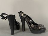 black high heeled shoes with a bow on the toe