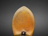 an image of a yellow stone lamp on a black surface