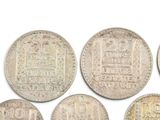 six different types of silver coins are shown on a white surface