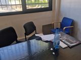 a table with a bottle of water and papers on it
