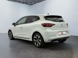 the rear end of a white car parked in a garage