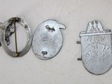 two silver metal objects sitting next to each other on a white surface