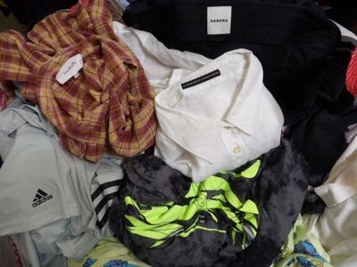 une pile de vêtements posée sur un lit