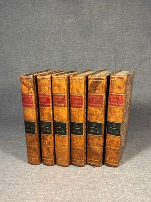 a set of five old books sitting on top of each other
