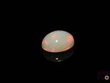 a white oplite in the dark with a black background