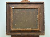 an old wooden easel with a painting on top of it