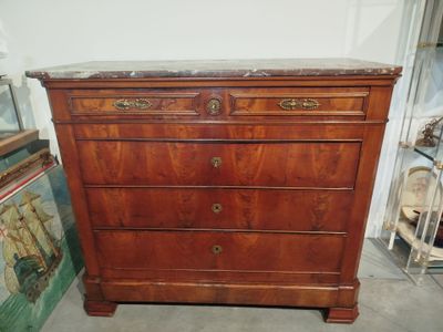 a wooden dresser with marble top in a room