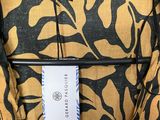 an image of a yellow and black dress with a tag on it