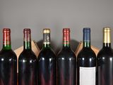 several bottles of wine are lined up in a row on a table