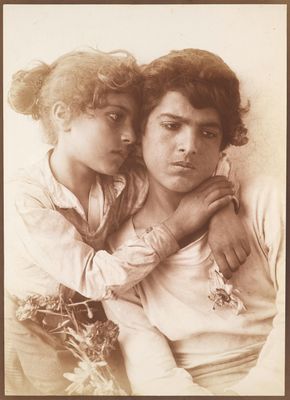 an old photo of a woman holding a child in her arms