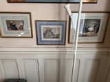 a picture of a bathroom with a toilet and pictures on the wall