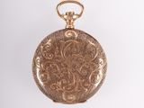 an antique gold pocket watch with a chain on a white background