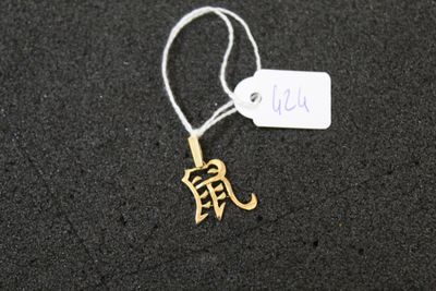 a tag that has a small gold elephant on it