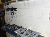 a picture of a kitchen with a lot of utensils on the counter