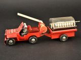 a toy fire truck with a fireman in the back of it