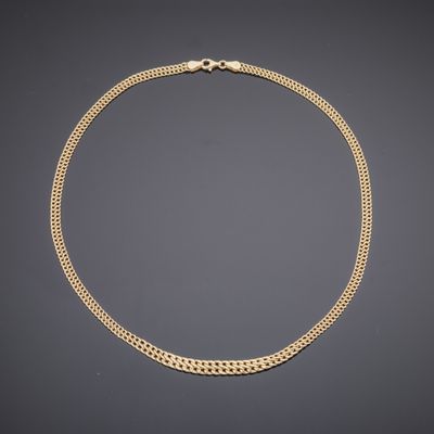 a gold chain necklace with a clasp on a black background