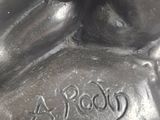 a silver statue of a horse that is sitting on a table