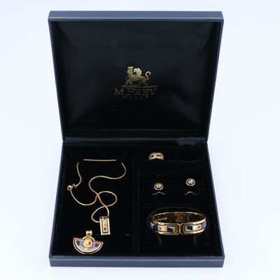 a black box with a necklace, bracelet, and ring in it