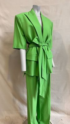the mannequin is wearing a green suit with a belt