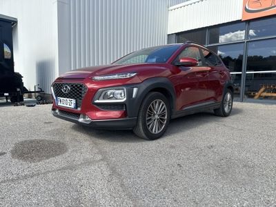 the red car is parked outside of a building in front of a building