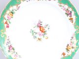 a plate with a floral design on it on a table