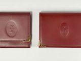two red leather wallets with a gold clasp on each of them