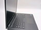a black laptop with a silver keyboard on a white surface