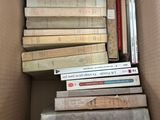a box full of books that are stacked on top of each other