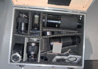 a metal case with many different types of cameras in it
